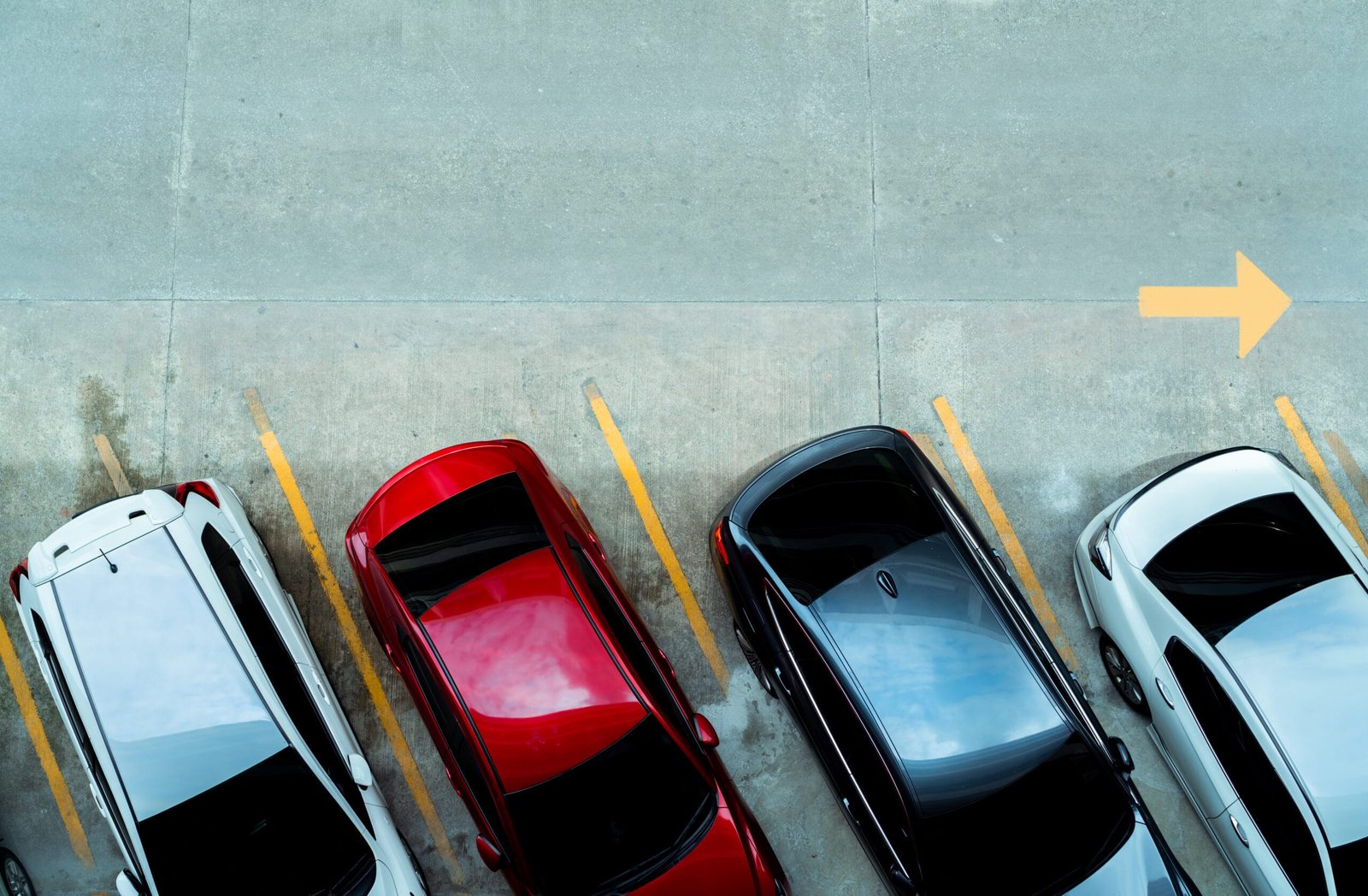 Top view of car parked at concrete car parking lot with yellow l